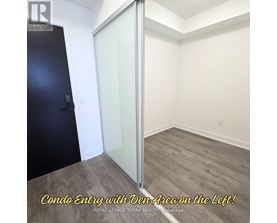 A room with a condo entry and a den area on the left.