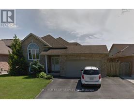 A house with a car parked in front and Spectrum Realty Services Inc. Brokerage written on the image.