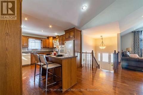 A modern kitchen with wooden cabinets and a dining table.