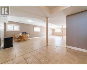 A spacious room with a dining table and chairs.