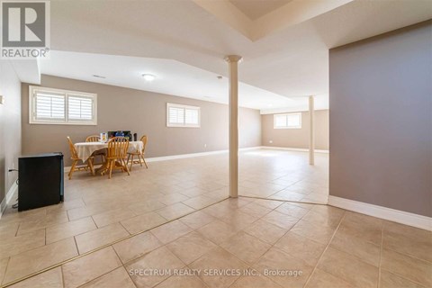 A spacious room with a dining table and chairs.