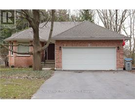 A house with a white garage door is for sale.