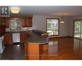 A kitchen with wooden cabinets and a large island.