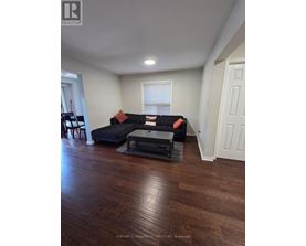 A living room with a black couch and a coffee table.