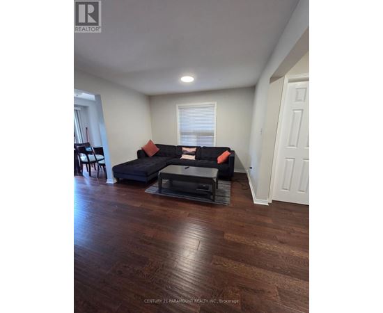 A living room with a black couch and a coffee table.