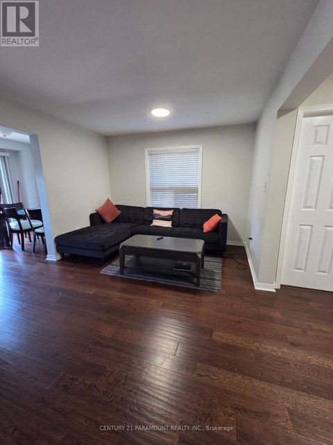 A living room with a black couch and a coffee table.