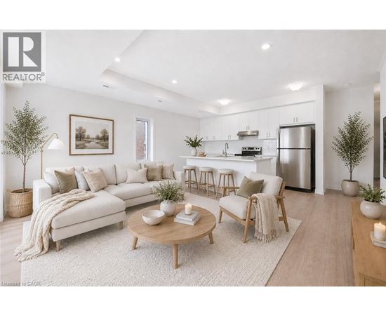 A modern living room with a white sofa, wooden coffee table, and a kitchen in the background.
