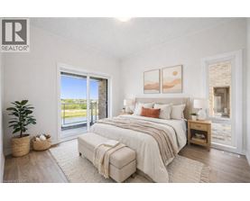 A bedroom with a large bed and a sliding glass door.