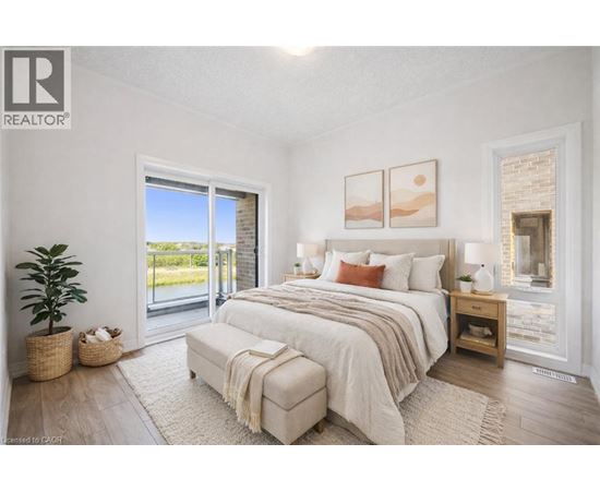 A bedroom with a large bed and a sliding glass door.