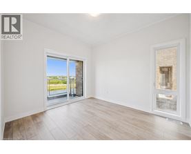 A room with a sliding glass door leading to a balcony.