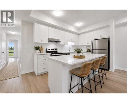 A modern kitchen with white cabinets and a central island.