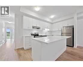 A modern kitchen with white cabinets and a large island.
