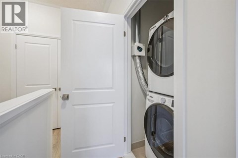 A white door is open to reveal a washing machine.