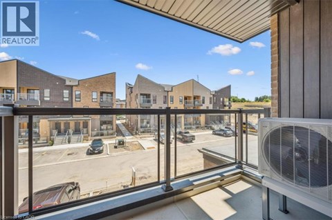 A view from a balcony overlooking a parking lot and a building with the logo REALTOR.