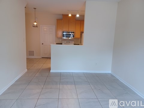 A kitchen area with a counter and cabinets in the background.