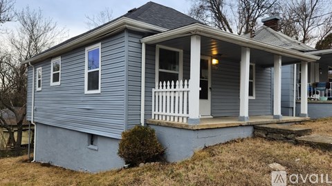 A small house with a porch and a single window.