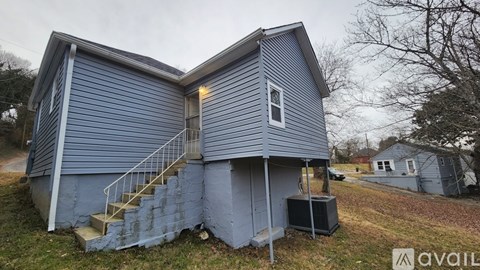 A blue house with a staircase leading to the second floor.