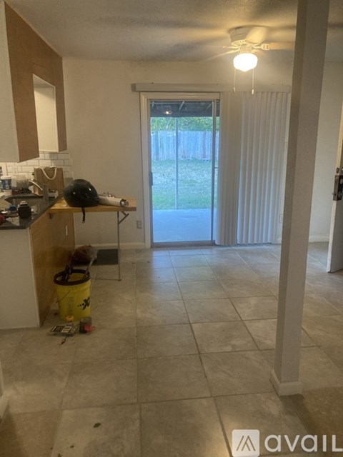 A kitchen with a yellow bucket on the floor.