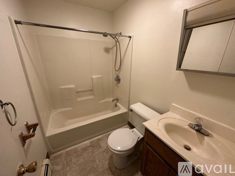 A bathroom with a toilet, sink, and bathtub.