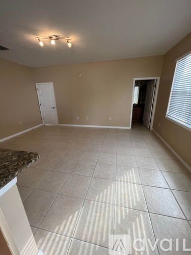 A room with beige walls and a tiled floor.