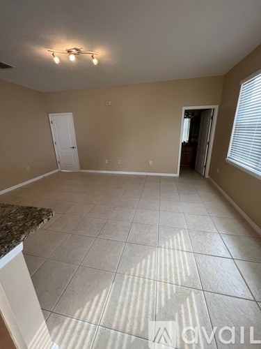 A room with beige walls and a tiled floor.