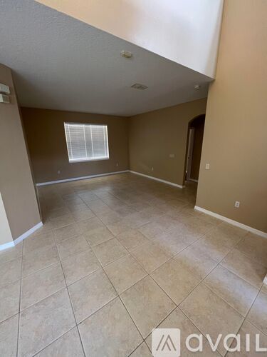 A room with beige walls and tile flooring is available for rent.