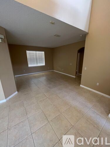 A room with beige walls and tile flooring is available for rent.
