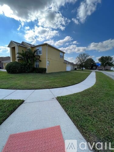 A yellow building with a red and white walkway in front of it.