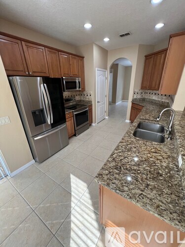 A kitchen with granite countertops and stainless steel appliances.