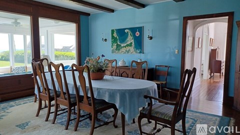 A dining room with a table set for six.