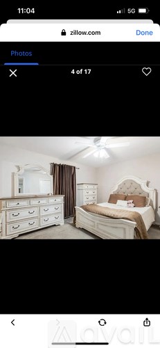 A bedroom with a bed, dresser, and nightstand.