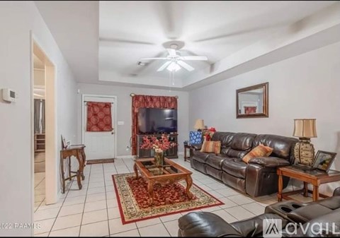 A living room with a brown leather couch and a wooden coffee table.