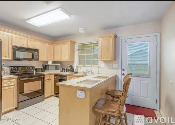 A kitchen with wooden cabinets and a white countertop.