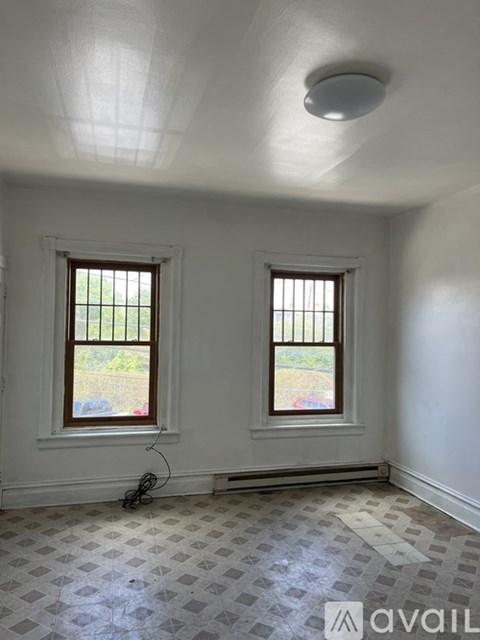 A room with two windows and a checkered floor.
