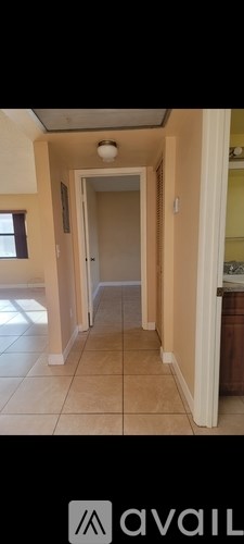 A hallway with a door at the end.
