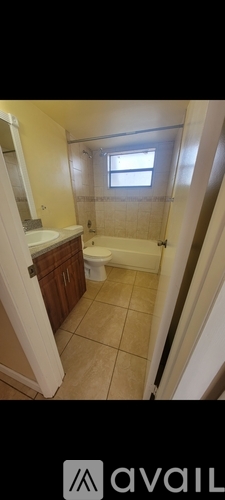 A bathroom with a toilet, sink, and bathtub.