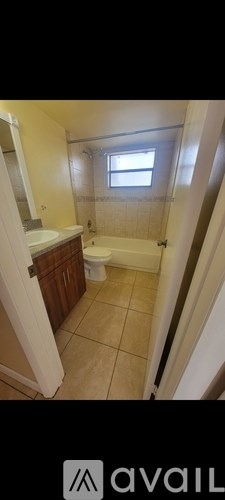A bathroom with a toilet, sink, and bathtub.