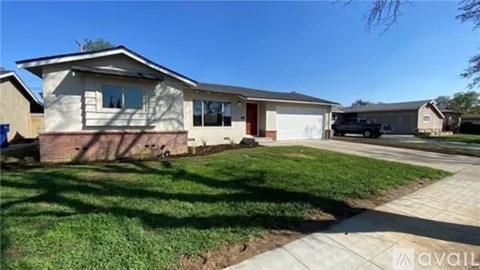 A house with a brown and white exterior is available for rent.