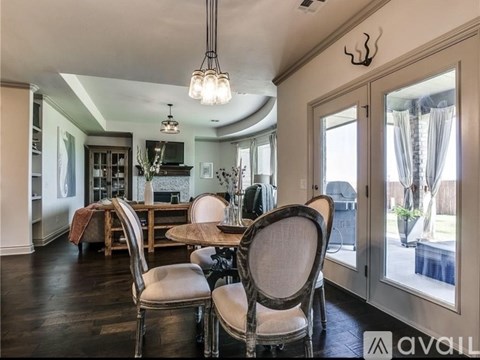 A dining room with a table and chairs is shown.