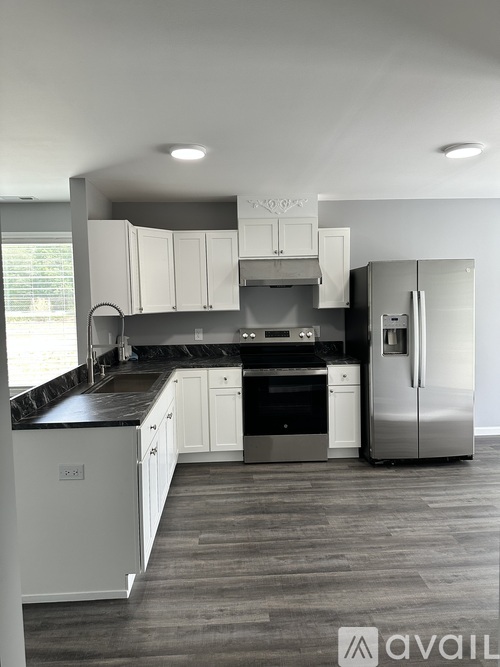 A modern kitchen with a refrigerator on the right side.