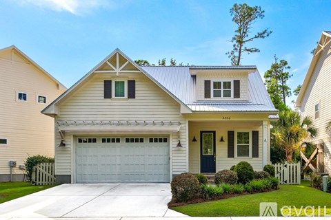 A two-story house with a garage is for sale.