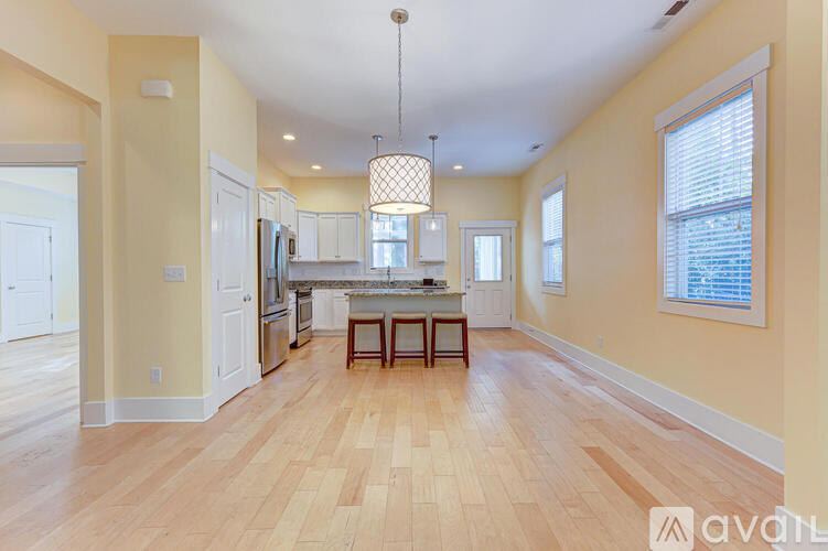 A kitchen with wooden floors and a central island.