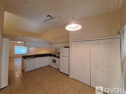 A kitchen with white cabinets and appliances.