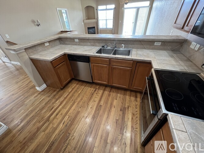 A kitchen with wooden floors and a large island.