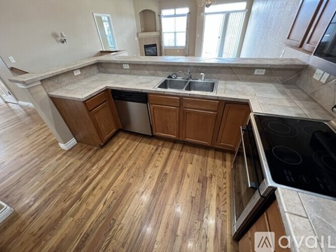 A kitchen with wooden floors and a large island.