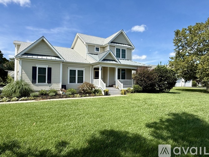 A house with a well-maintained lawn in front of it.