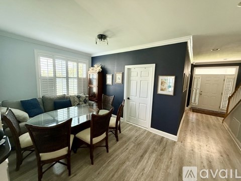 A dining room with a glass table and chairs.