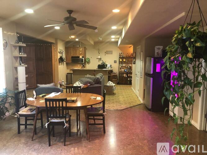 A dining room with a table set for four.