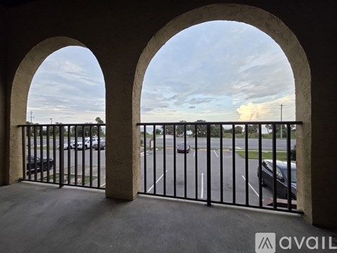 A view from a balcony looking out at a parking lot.
