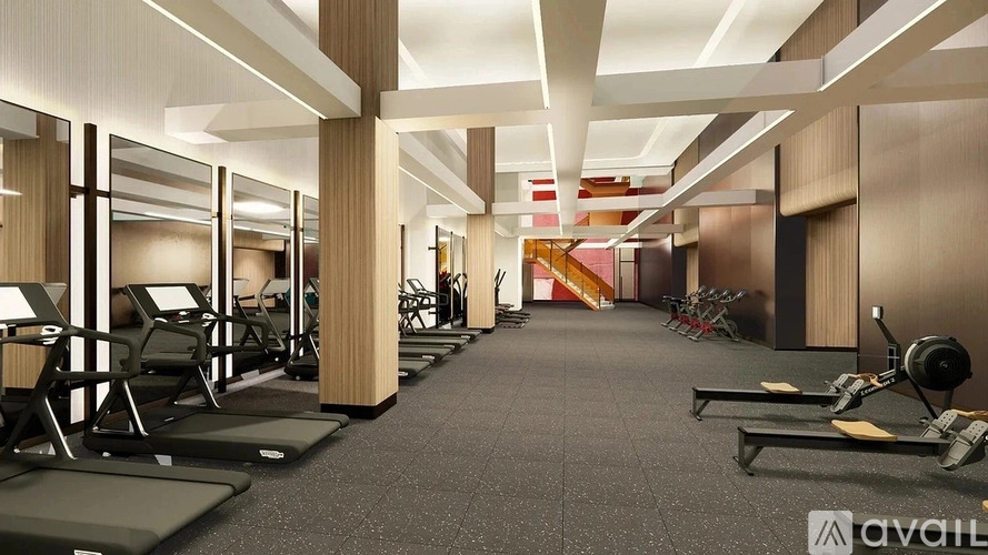 A gym with treadmills, weights, and mirrors.